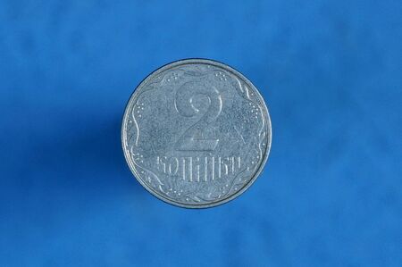 small white Ukrainian two pennies on a blue background