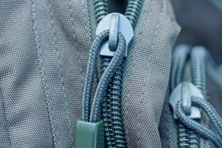 one green gray metal zip on the backpackの写真素材