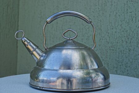 a large gray metal kettle closed with a lidの写真素材