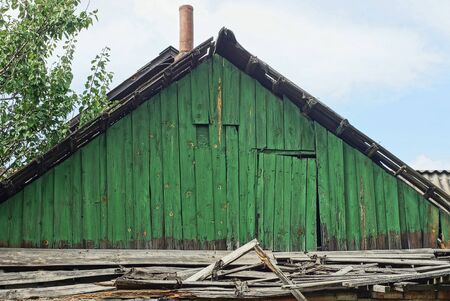 old green wooden loft with the door of a rural houseの写真素材