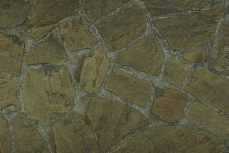 Gray brown texture of a stone wall of an old house