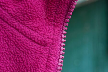 plastic zip on red cloth clothes on a green background