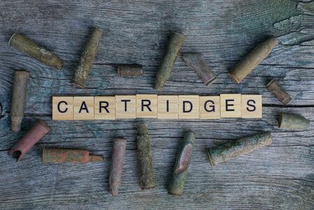 word cartridges from letters on a table with old sleevesの写真素材