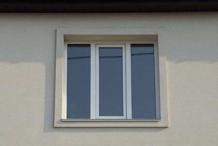one big white square window on a gray wall