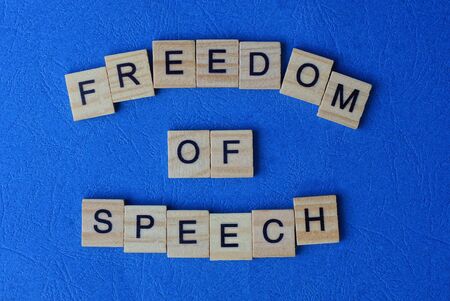 phrase freedom of speech from wooden letters on a blue tableの写真素材