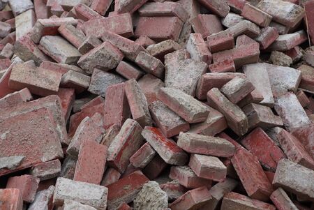 gray brown stone texture of old bricks in a pile of garbageの写真素材