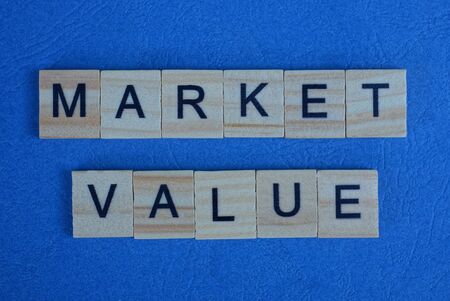 phrase market value made from gray wooden letters lies on a blue backgroundの写真素材