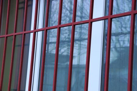 metal texture of red forged rods with a pattern on the white window