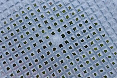 light white texture from a plastic basket latticeの写真素材