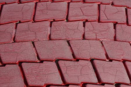 red plastic texture from an old dirty car tire with cracksの写真素材