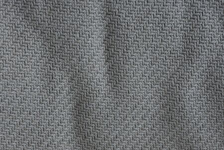 Gray fabric background from a crumpled piece of clothの写真素材