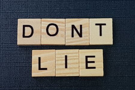 phrase on dont lie from gray wooden letters on a black backgroundの写真素材