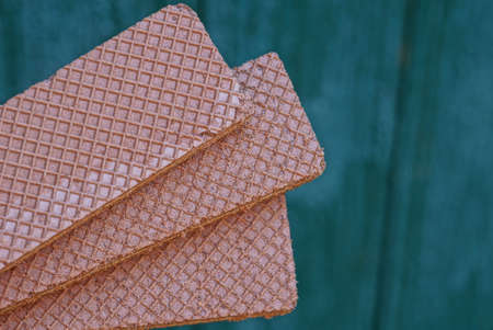 food of three long brown waffles on a green background
