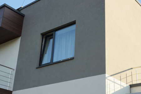 big black square large window on the gray concrete wall of the building