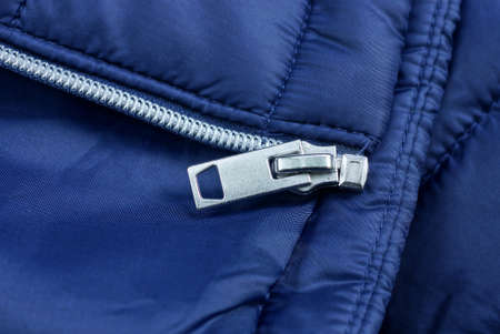 white open metallic zip on blue synthetic clothing fabric