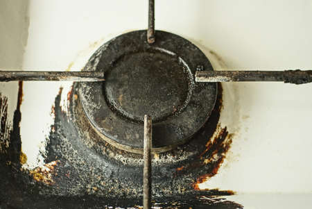 one black round iron gas burner on a burnt metal gas stoveの写真素材