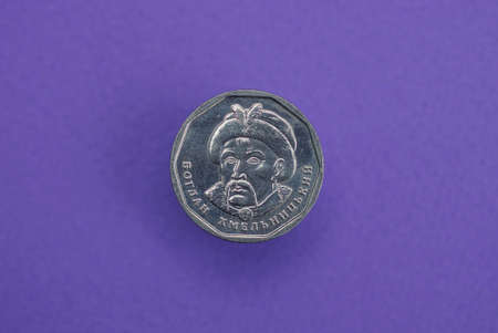 one new gray coin of Ukraine five hryvnia lies on a lilac tableの写真素材