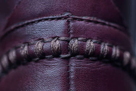 red dark leather texture on shoes with a seamの写真素材