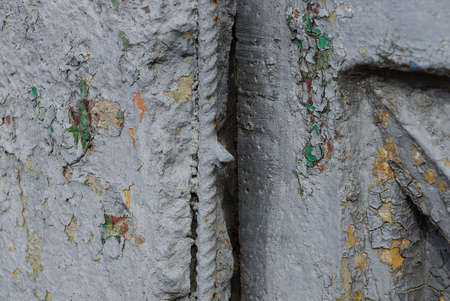 a piece of gray broken concrete wall with iron reinforcement