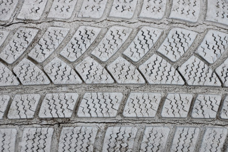 gray white plastic texture from an old dirty car tire with cracksの写真素材