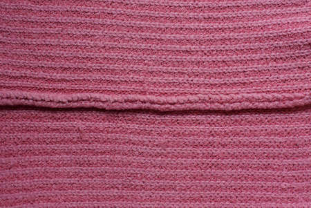 red texture of fabric from a piece of wool with a seam
