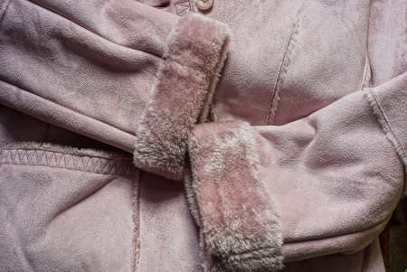 part of a gray brown suede jacket with two sleeves with furの写真素材
