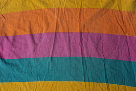 bright colored striped fabric background of a piece of crumpled cloth