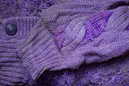 fabric texture of lilac wool knitted sweater with dirty old sleeve and buttonの写真素材