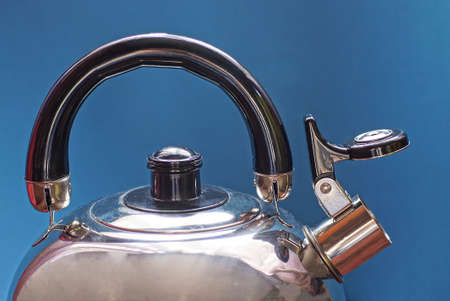 one gray metal kettle with a whistle and a black plastic handle on a blue background