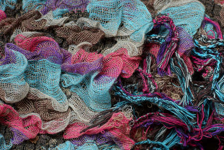 bright background of colored woolen fabric on old clothes