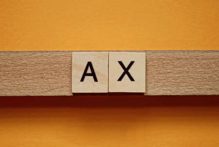 gray word ax made of wooden square letters on brown backgroundの写真素材
