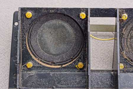 one old dirty black speaker on a broken electrical applianceの写真素材