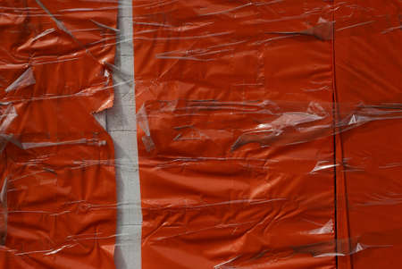 red plastic texture from crumpled cellophane wrapped with white hole