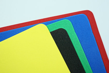 set of colored sheets of paper and plastic lie on a white tableの写真素材