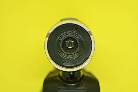 one small plastic black webcam lies on a yellow backgroundの写真素材