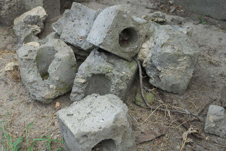 a pile of rubbish from pieces of old gray bricks on the ground in the street