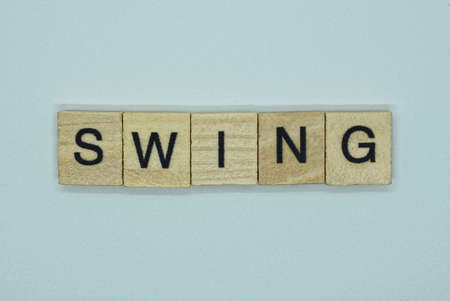 text on word swing from brown wooden letters on a white background