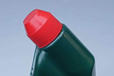 one green plastic bottle with red cork on a gray backgroundの写真素材