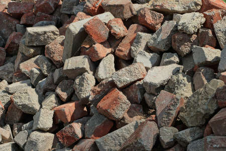 stone texture made of debris from pieces of gray red bricksの写真素材