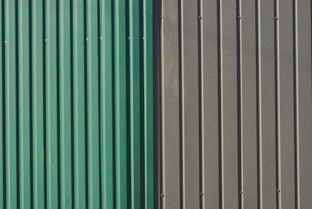 colored texture from a part of a metal gray green wall with stripedの写真素材