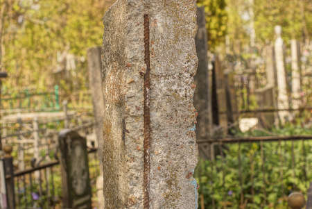 one old gray concrete pillar with rusty rebar stands on the streetの写真素材