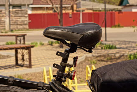 one black gray leather saddle on the frame of a sports bike on the streetの写真素材