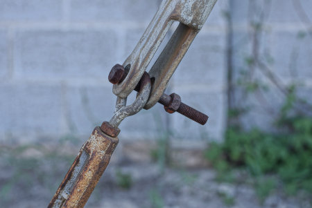 part of a gray metal old structure with fasteners and plates with a brown rusty bolt on the streetの写真素材