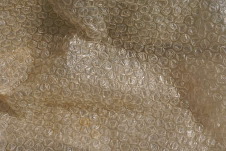 gray plastic texture from an old crumpled cellophane package with pimples