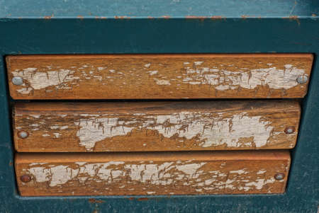 wooden texture of gray brown boards in a wall in a green metal frameの写真素材