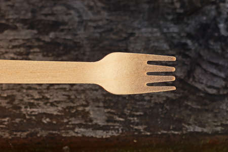 one brown wooden fork on a gray backgroundの写真素材