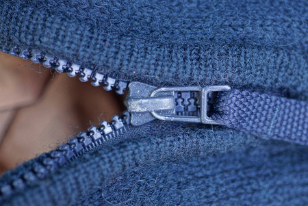 part of a gray blue wool jumper with an open metal zipの写真素材