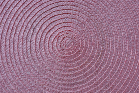 pink wooden texture from a piece of woven paper rugの写真素材