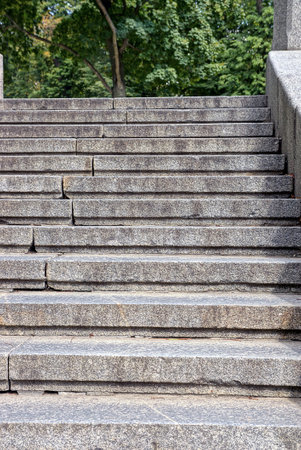 decorative concrete staircase with steps near stone gray pavement in summer parkの写真素材
