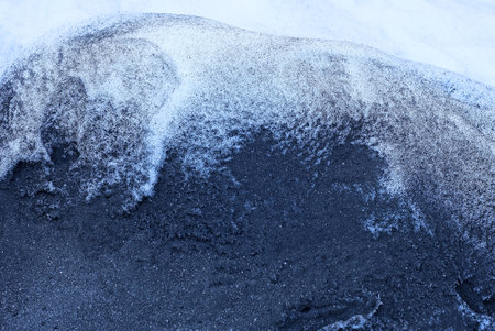 black and white texture from the ashes of a fire and snowの写真素材